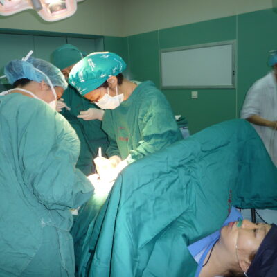 Doctors perform a c-section on an expectant mother.