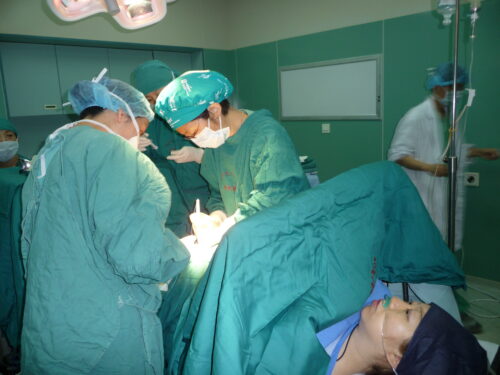 Doctors perform a c-section on an expectant mother. 