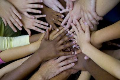 A large amount of diverse hands placed on top of one another. 