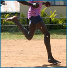 Photo of a person's legs as they run barefoot.