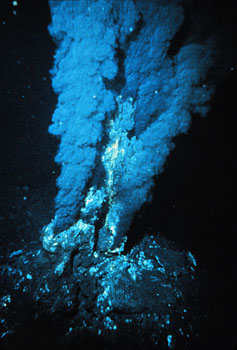 A deep sea vent spews a plume of black material