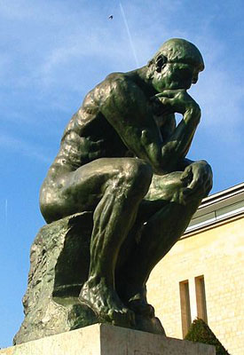 Sculpture of naked man, seated, with head resting on fist.